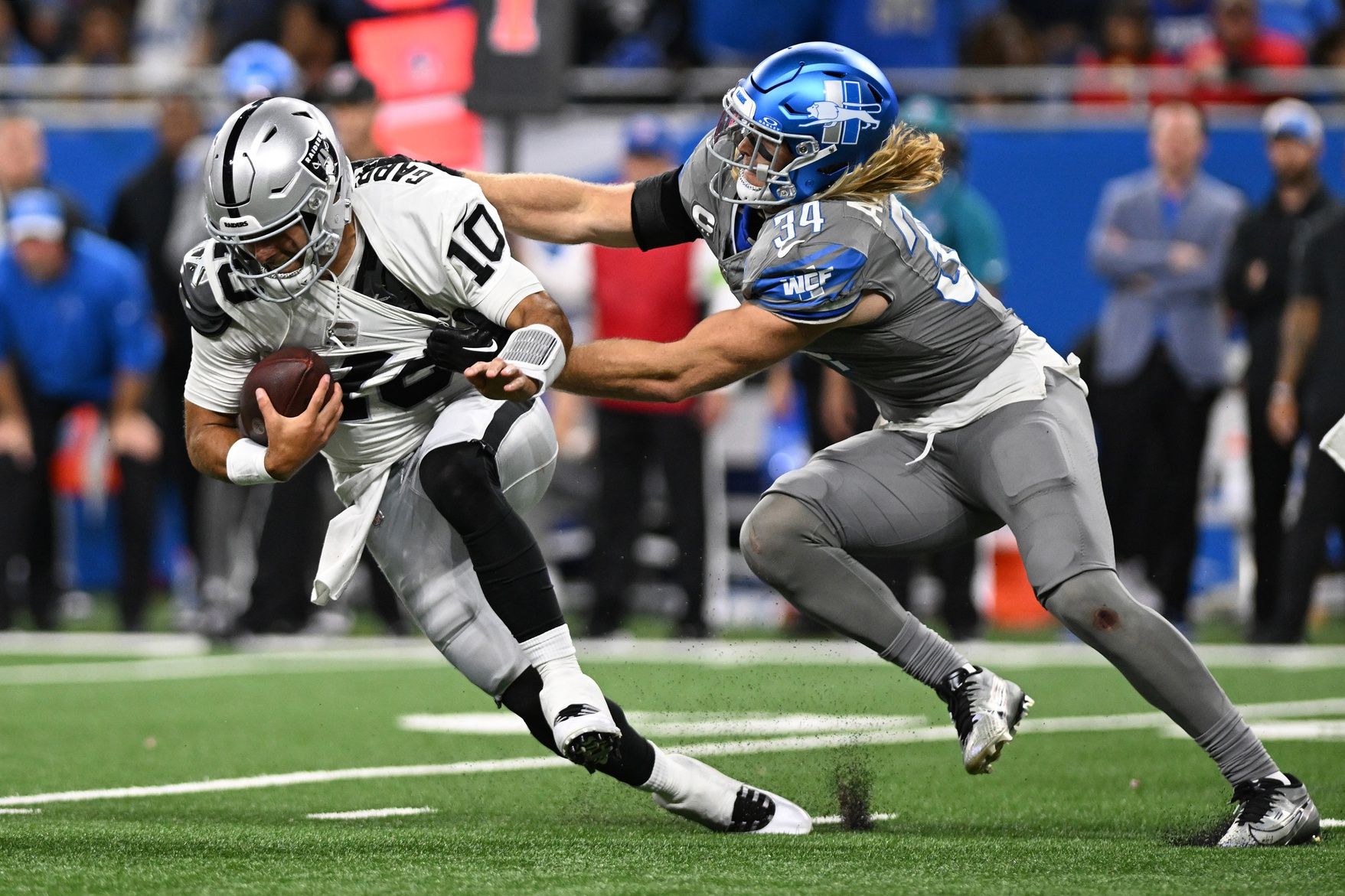 Detroit Lions linebacker Alex Anzalone (34) sacks Las Vegas Raiders quarterback Jimmy Garoppolo (10) in the fourth quarter at Ford Field.