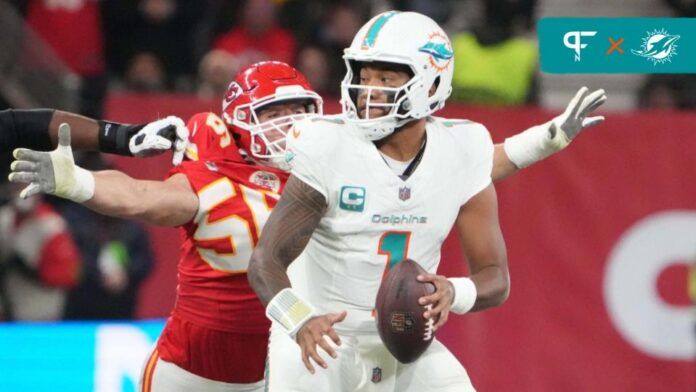 Miami Dolphins quarterback Tua Tagovailoa (1) throws the ball under pressure from Kansas City Chiefs defensive end George Karlaftis (56).