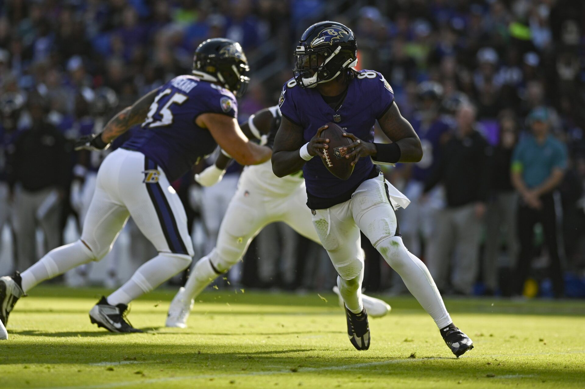 Baltimore Ravens QB Lamar Jackson (8) rolls out to pass against the Seattle Seahawks.