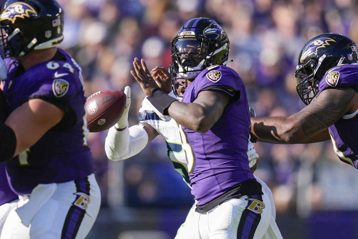 Seattle Seahawks linebacker Boye Mafe (53) knocks the ball out of the hands of Baltimore Ravens quarterback Lamar Jackson (8) and forces a fumble during the first half at M&T Bank Stadium.