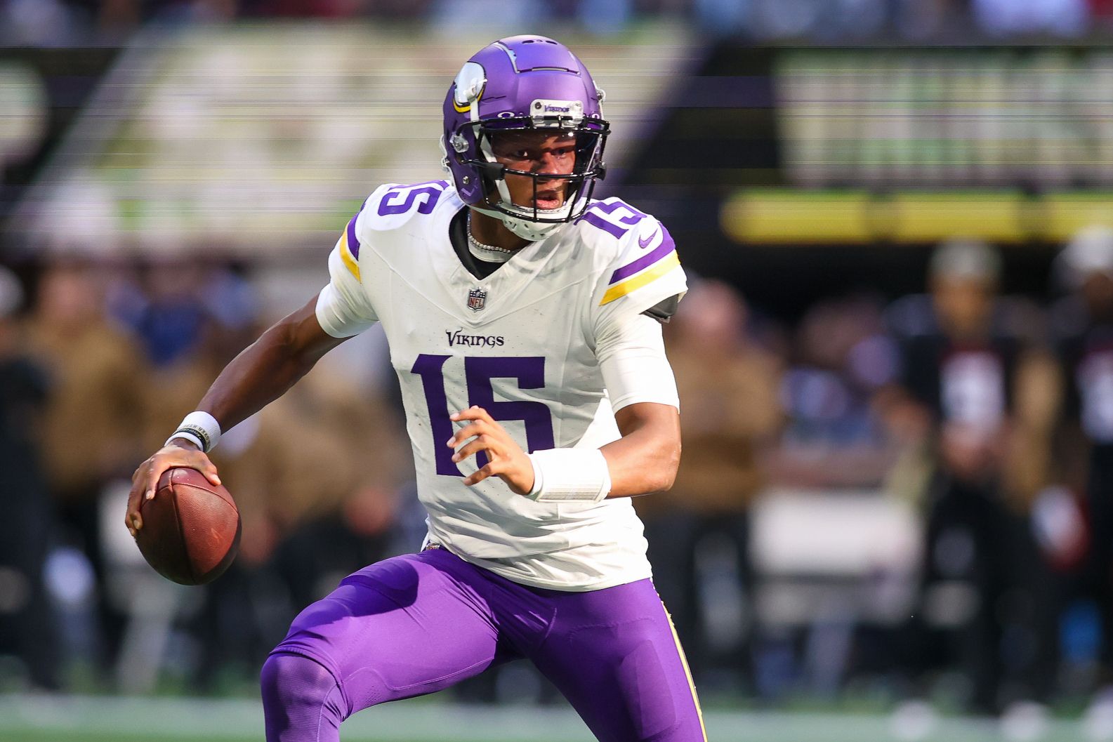 Minnesota Vikings quarterback Joshua Dobbs (15) scrambles against the Atlanta Falcons in the second half at Mercedes-Benz Stadium.