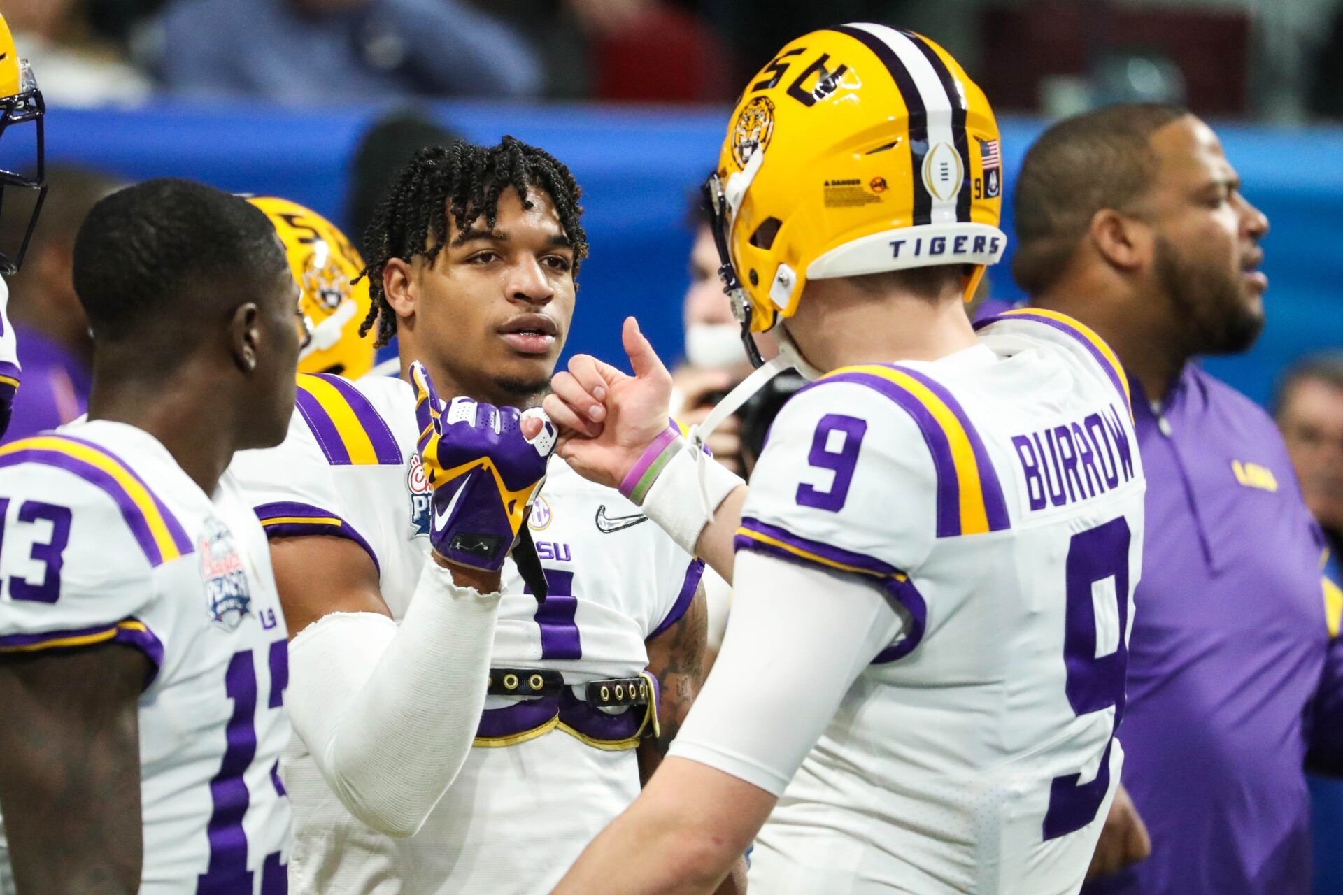 LSU Tigers wide receiver Ja'Marr Chase (1) greets quarterback Joe Burrow (9) before the 2019 Peach Bowl college football playoff semifinal game between the LSU Tigers and the Oklahoma Sooners at Mercedes-Benz Stadium.