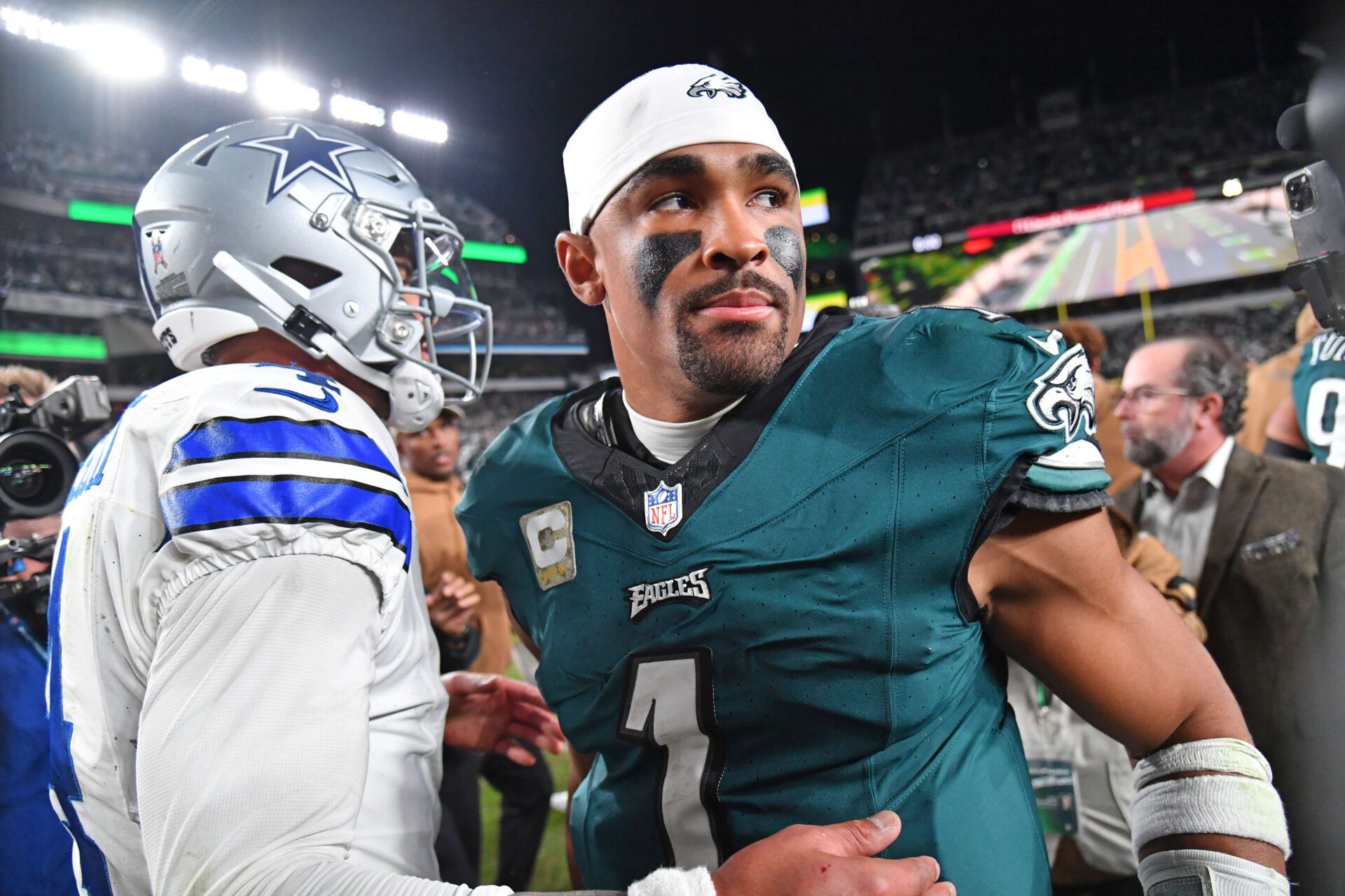 Dallas Cowboys quarterback Dak Prescott (4) and Philadelphia Eagles quarterback Jalen Hurts (1) meet on the field after Eagles win at Lincoln Financial Field.