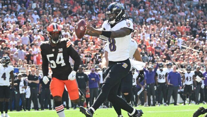 Baltimore Ravens quarterback Lamar Jackson (8) scores a touchdown during the first half against the Cleveland Browns at Cleveland Browns Stadium.