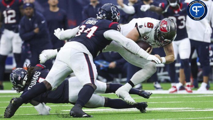 Tampa Bay Buccaneers quarterback Baker Mayfield (6) dives for a first down as Houston Texans defensive tackle Khalil Davis (94) attempts to make a tackle.