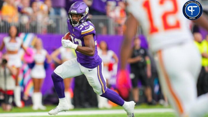 Ty Chandler (32) runs with the ball after a fake punt against the Kansas City Chiefs in the second quarter at U.S. Bank Stadium.