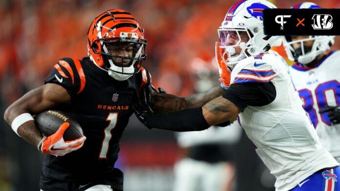 Ja'Marr Chase (1) stiff arms Buffalo Bills cornerback Taron Johnson (7) after a catch in the fourth quarter.