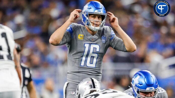 Jared Goff (16) talks to teammates before a play against Las Vegas Raiders during the first half at Ford Field.