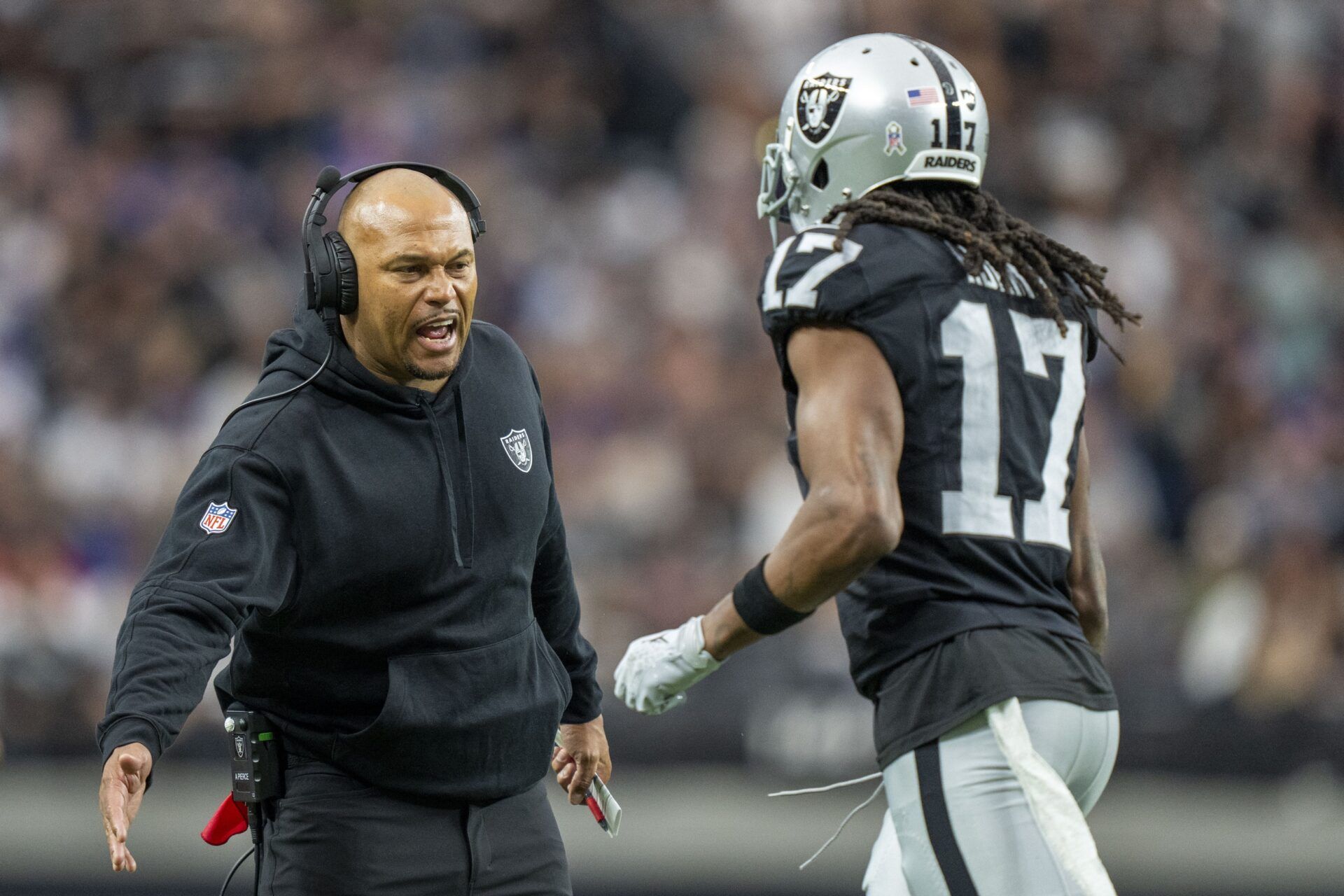 Las Vegas Raiders interim head coach Antonio Pierce (left) high-fives wide receiver Davante Adams (17) after a touchdown against the New York Giants.