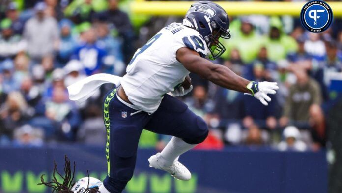 Seattle Seahawks running back Zach Charbonnet (26) breaks a tackle attempt by Carolina Panthers cornerback Donte Jackson (26) during the third quarter at Lumen Field.