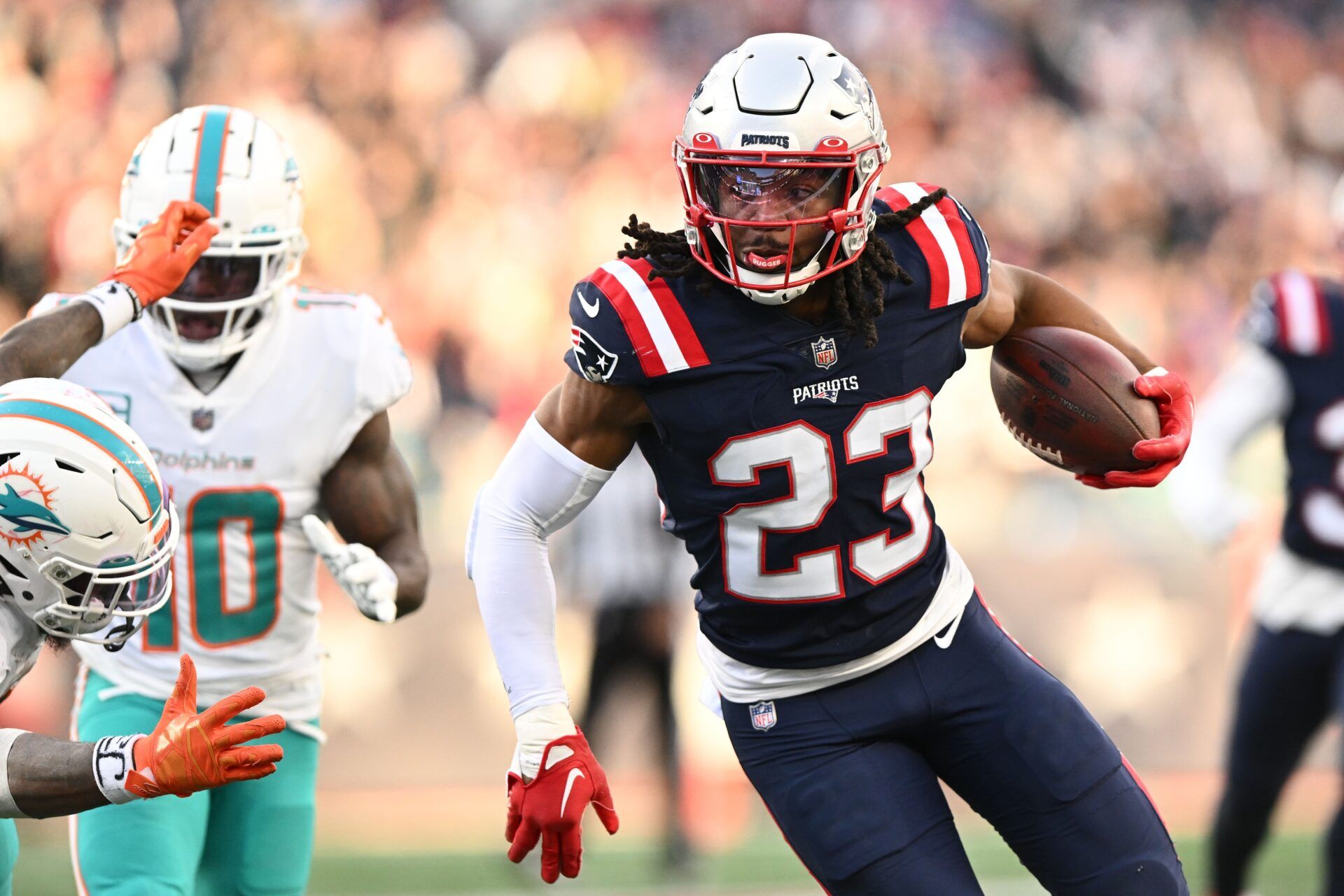 Kyle Dugger (23) runs for a touchdown after intercepting the ball during the second half of agame against the Miami Dolphins at Gillette Stadium.