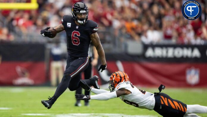 Arizona Cardinals running back James Conner (6) against diving Cincinnati Bengals cornerback Cam Taylor-Britt.