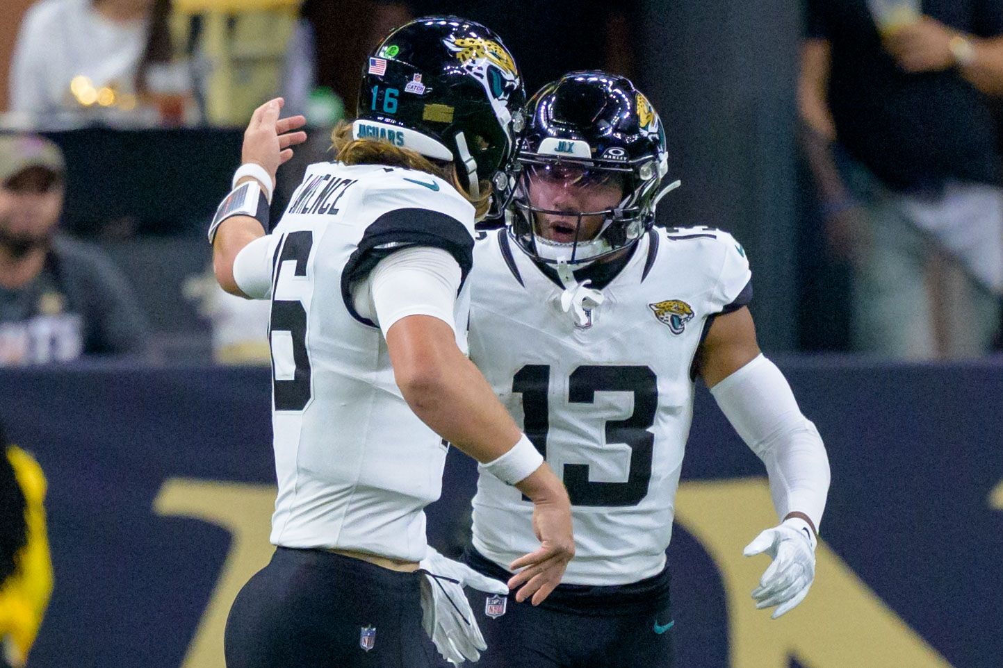 Jacksonville Jaguars quarterback Trevor Lawrence (16) celebrates a touchdown with wide receiver Christian Kirk (13) against the New Orleans Saints during the fourth quarter at the Caesars Superdome.