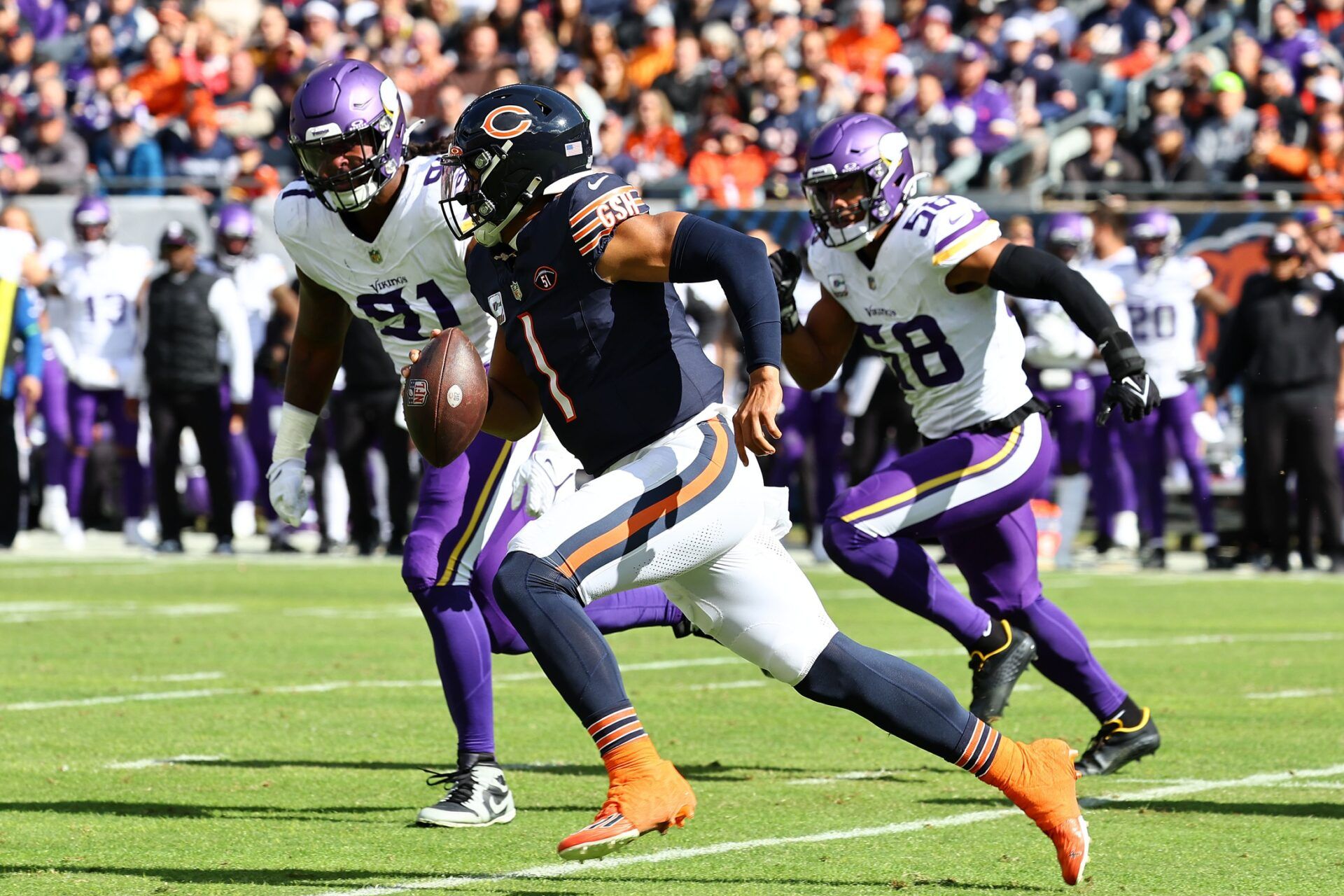 Chicago Bears QB Justin Fields (1) takes off running against the Minnesota Vikings.