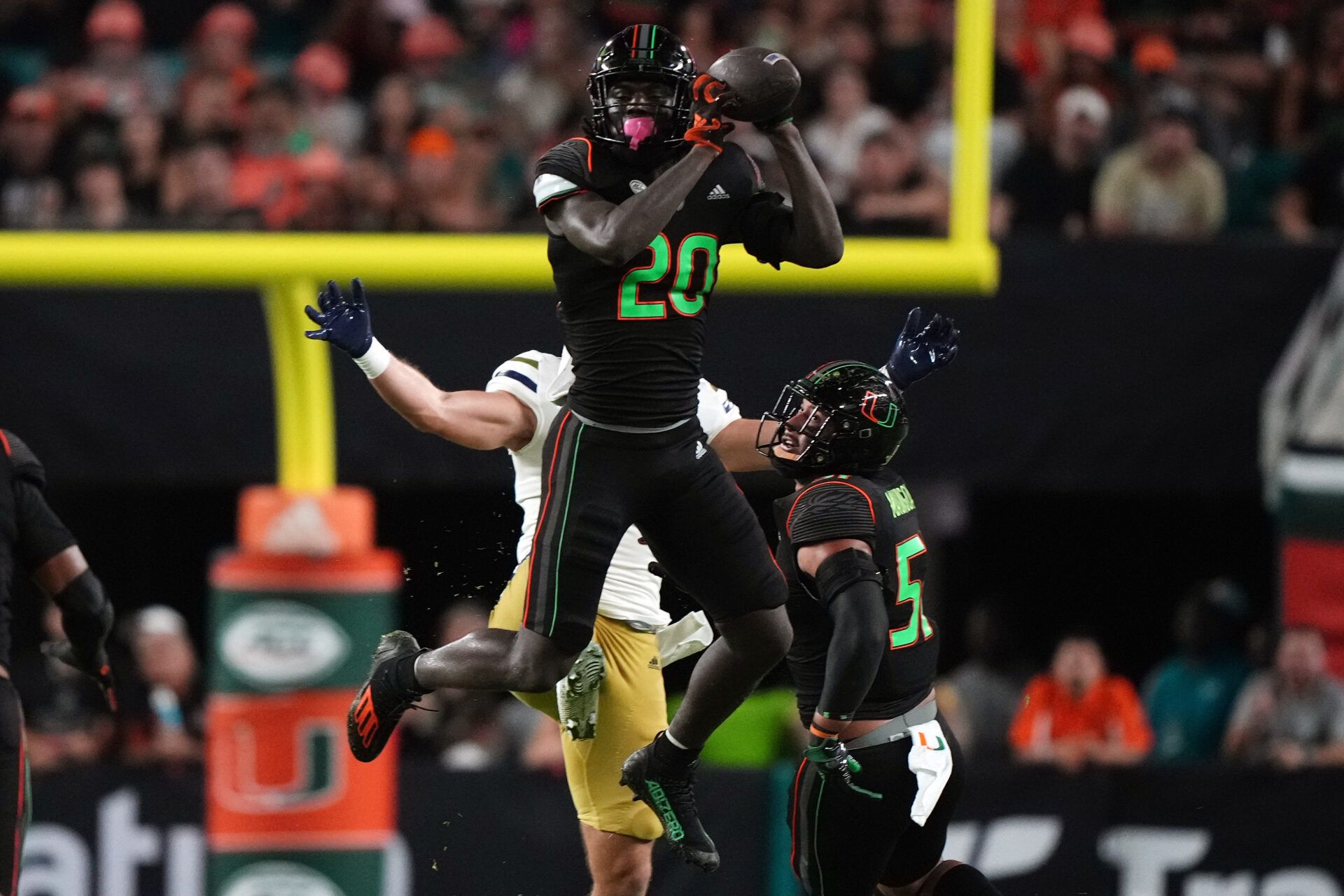 Miami Hurricanes safety James Williams (20) intercepts a pass against the Georgia Tech Yellow Jackets in the second half at Hard Rock Stadium.