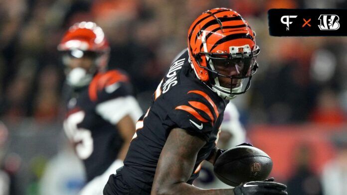 Tee Higgins (5) completes a catch as Buffalo Bills safety Jordan Poyer (21) defends in the fourth quarter during a Week 9 NFL football game.