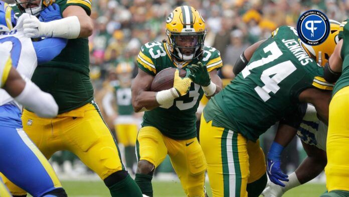 Green Bay Packers running back Aaron Jones (33) rushes against the Los Angeles Rams during their football game Sunday at Lambeau Field.