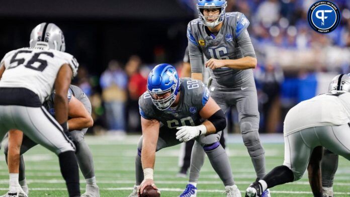 Jared Goff (16) talks to guard Graham Glasgow (60) before a snap against Las Vegas Raiders during the second half at Ford Field