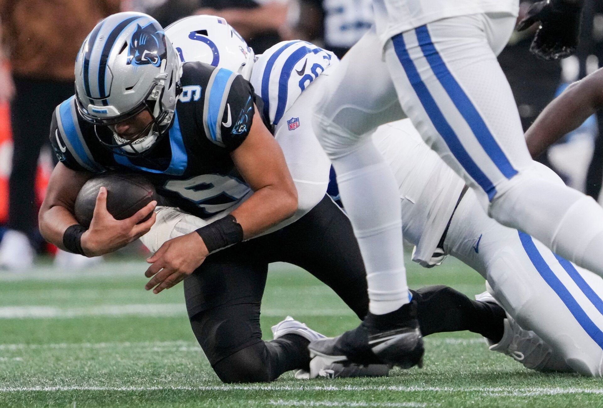 Indianapolis Colts defensive tackle DeForest Buckner (99) brings down Carolina Panthers quarterback Bryce Young (9).