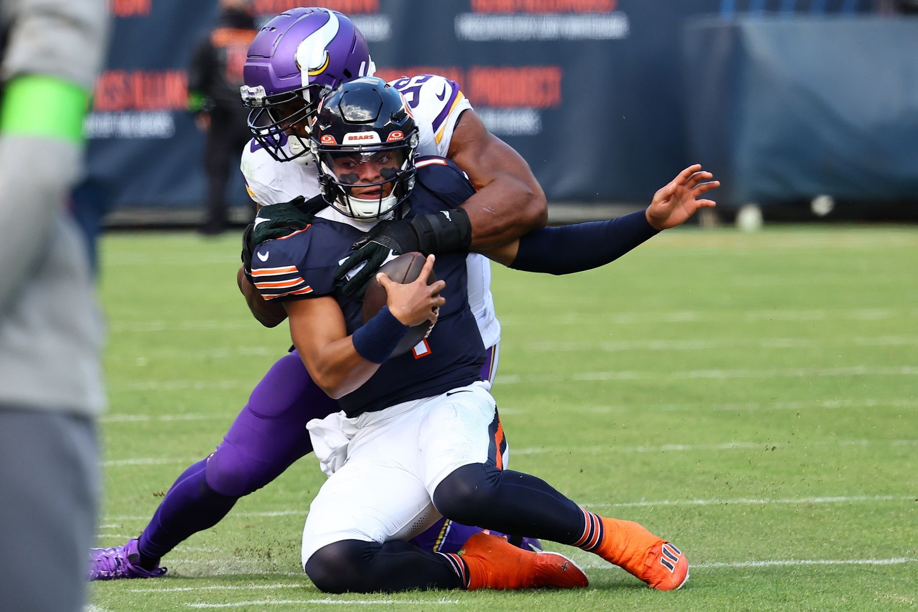 Minnesota Vikings linebacker Danielle Hunter (99) tackles Chicago Bears quarterback Justin Fields (1).