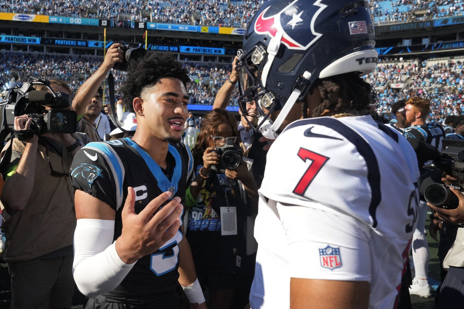 Houston Texans QB C.J. Stroud and Carolina Panthers QB Bryce Young (9) meet each other on the field after the game.