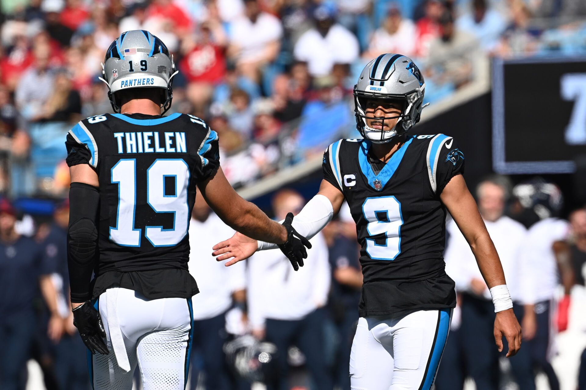 Carolina Panthers wide receiver Adam Thielen (19) and quarterback Bryce Young (9) react in the second quarter at Bank of America Stadium.