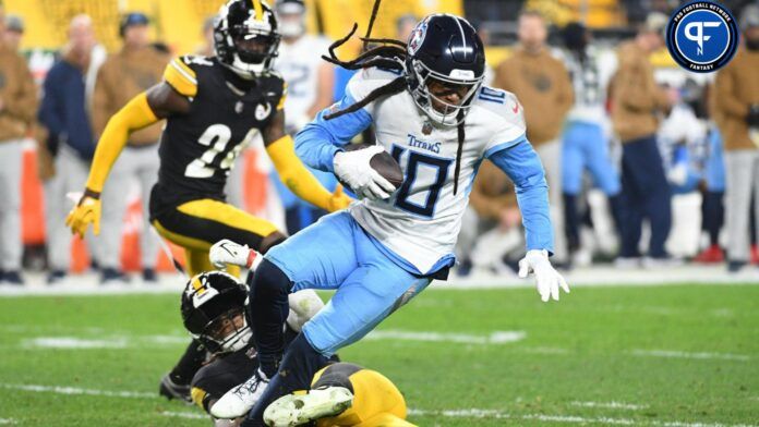 Tennessee Titans wide receiver DeAndre Hopkins (10) is tripped up by Pittsburgh Steelers linebacker Kwon Alexander (54) during the second quarter at Acrisure Stadium.