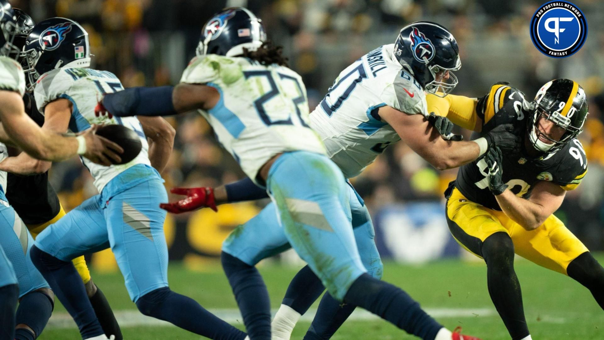 Pittsburgh Steelers linebacker T.J. Watt (90) is blocked by Tennessee Titans offensive tackle Daniel Brunskill (60) as quarterback Will Levis (8) hands off to running back Derrick Henry (22) during the fourth quarter of their game.