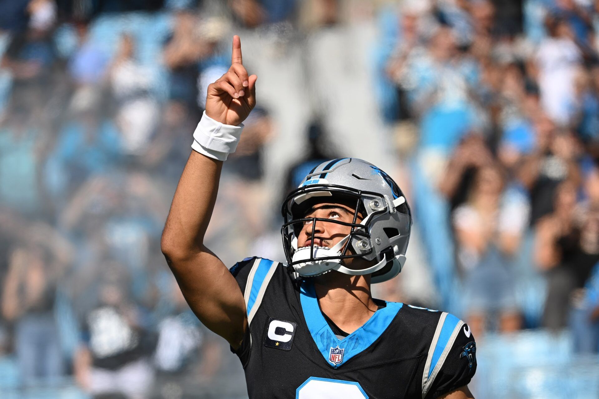 Bryce Young (9) runs on to the field before the game at Bank of America Stadium.