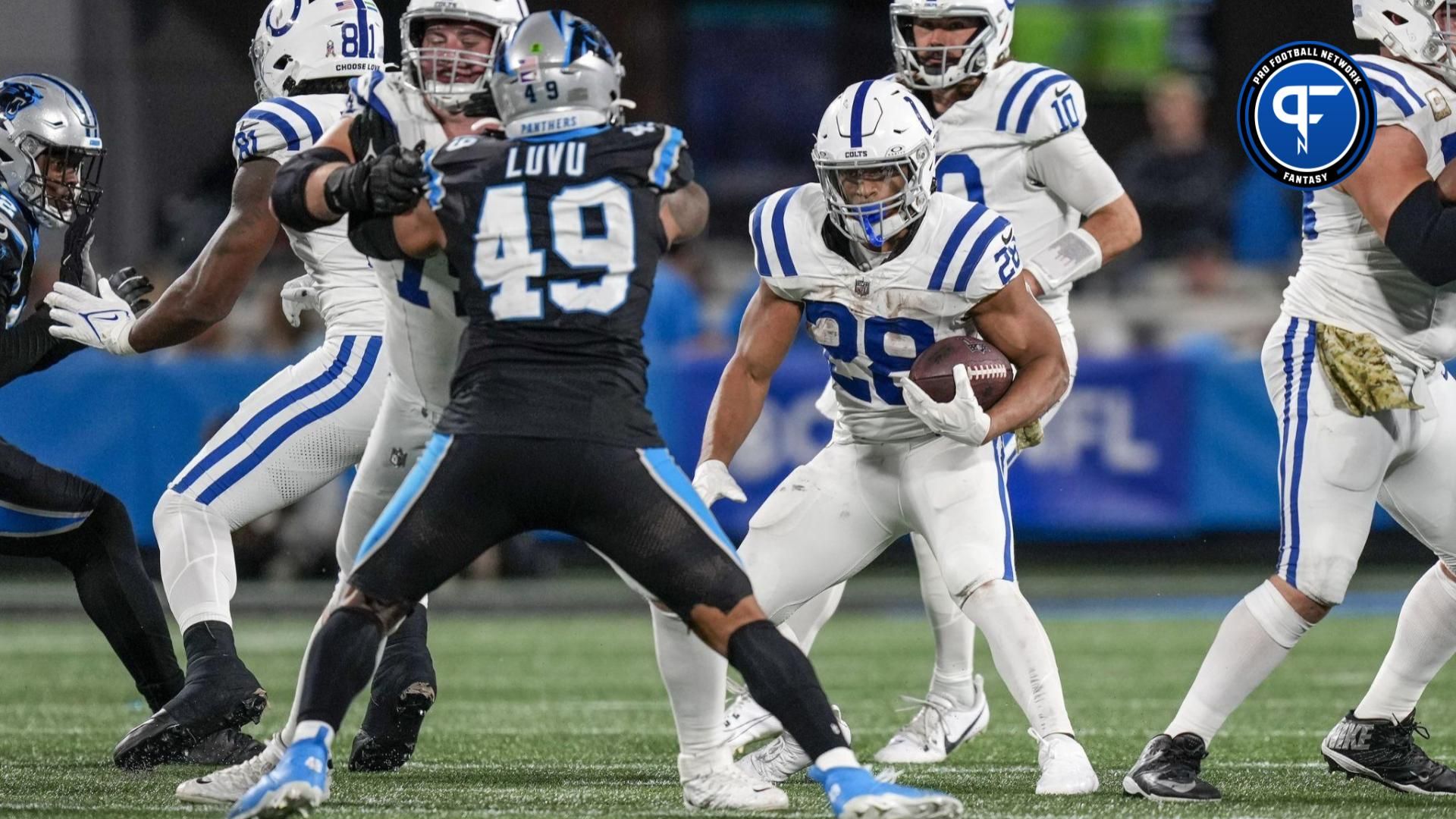 Indianapolis Colts running back Jonathan Taylor (28) runs through the blocks against the Carolina Panthers.