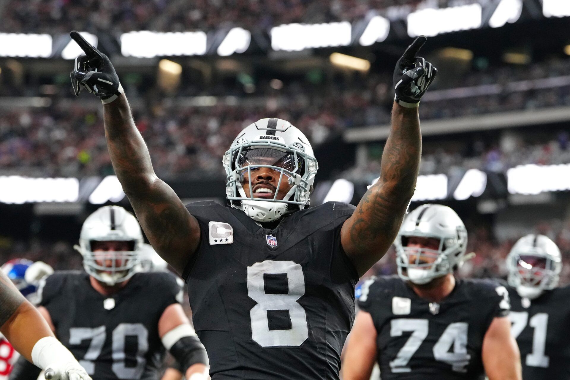 Las Vegas Raiders running back Josh Jacobs (8) celebrates after scoring a touchdown against the New York Giants during the second quarter at Allegiant Stadium.