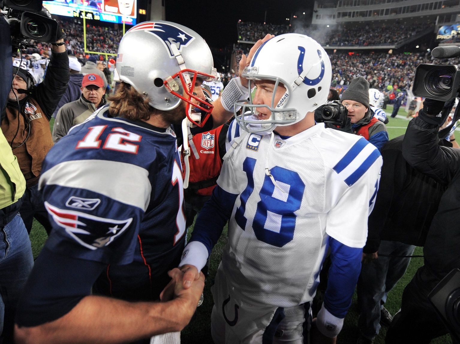 Indianapolis Colts quarterback Peyton Manning, right, meets with New England Patriots quarterback Tom Brady after a game at Gillette Stadium.