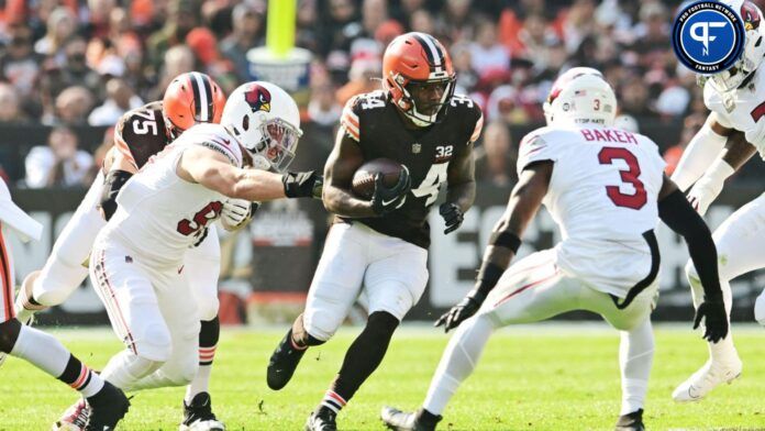 Jerome Ford (34) runs with the ball against Arizona Cardinals linebacker Cameron Thomas (97) and safety Budda Baker (3) during the first quarter at Cleveland Browns Stadium.