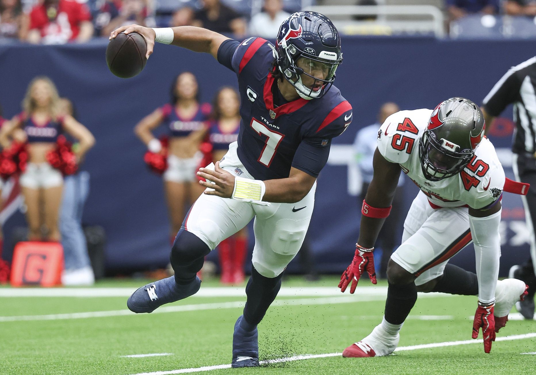 C.J. Stroud (7) scrambles with the ball as Tampa Bay Buccaneers linebacker Devin White (45) applies defensive pressure during the first quarter at NRG Stadium.