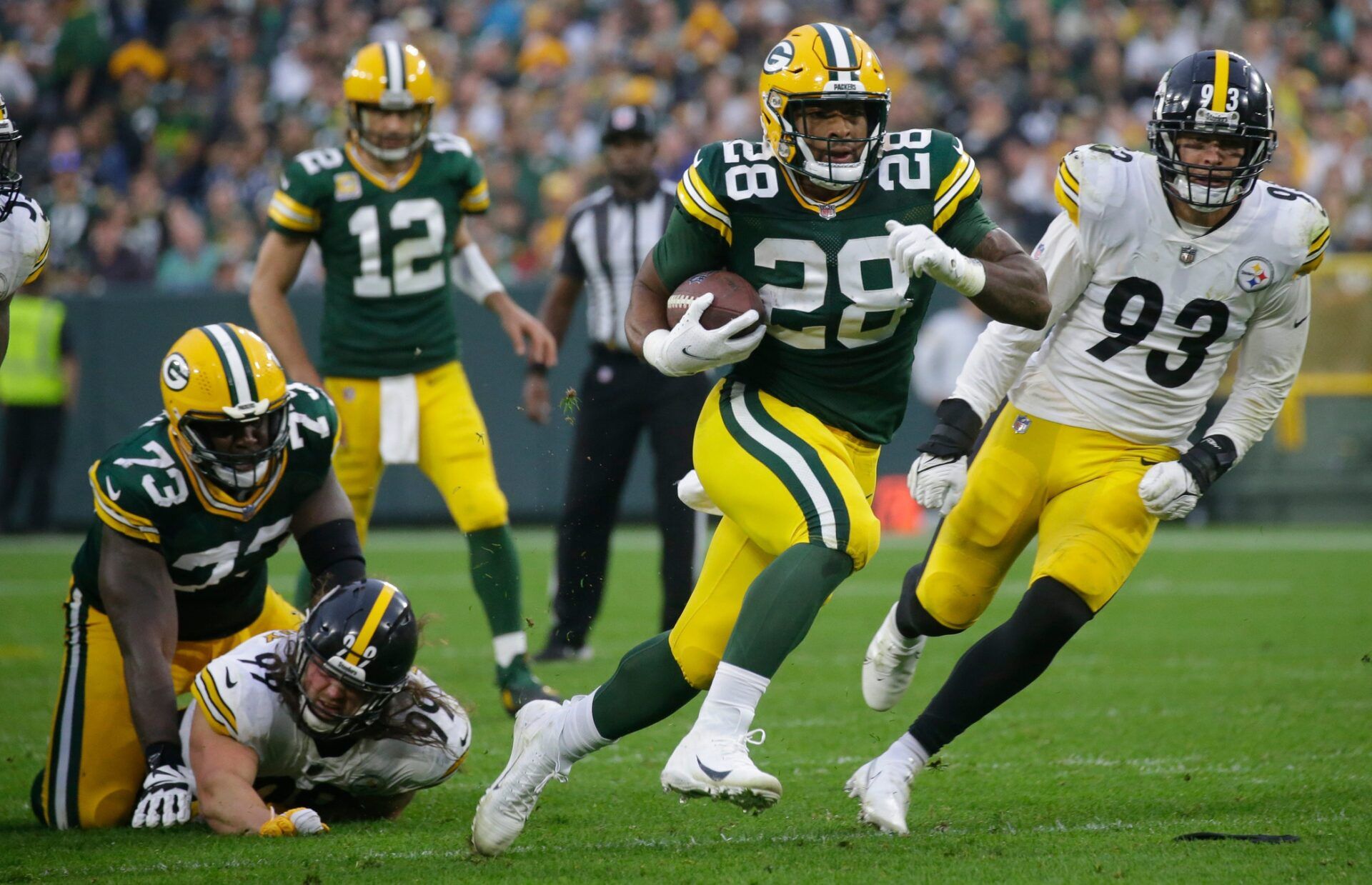 Green Bay Packers running back A.J. Dillon (28) burst through the Pittsburgh Steelers line to set up a touchdown during the third quarter of their game Sunday, October 3, 2021 at Lambeau Field in Green Bay, Wis. Green Bay Packers beat the Pittsburgh Steelers 27-17.