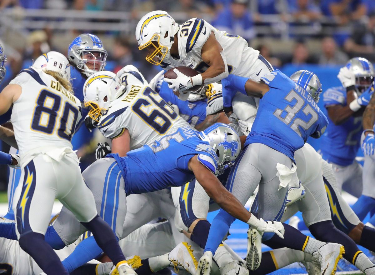 Los Angeles Chargers running back Austin Ekeler leaps at the goal line against Detroit Lions safety Tavon Wilson (32), then fumbles during the second half Sunday, Sept. 15, 2019 at Ford Field.