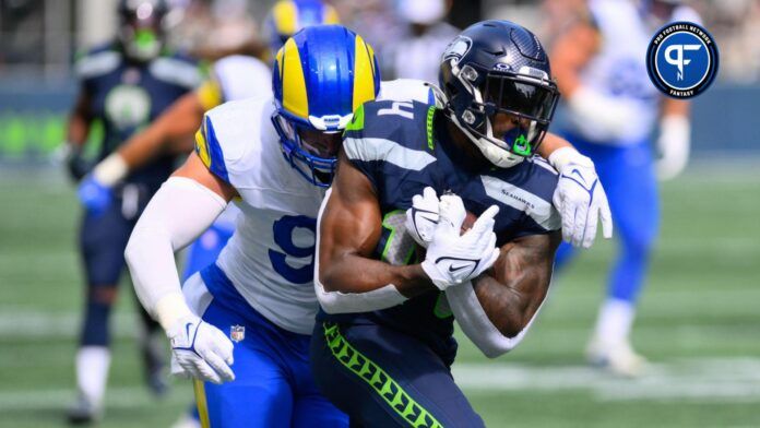 Seattle Seahawks wide receiver DK Metcalf (14) protects the ball from Los Angeles Rams linebacker Michael Hoecht (97) during the first half at Lumen Field.