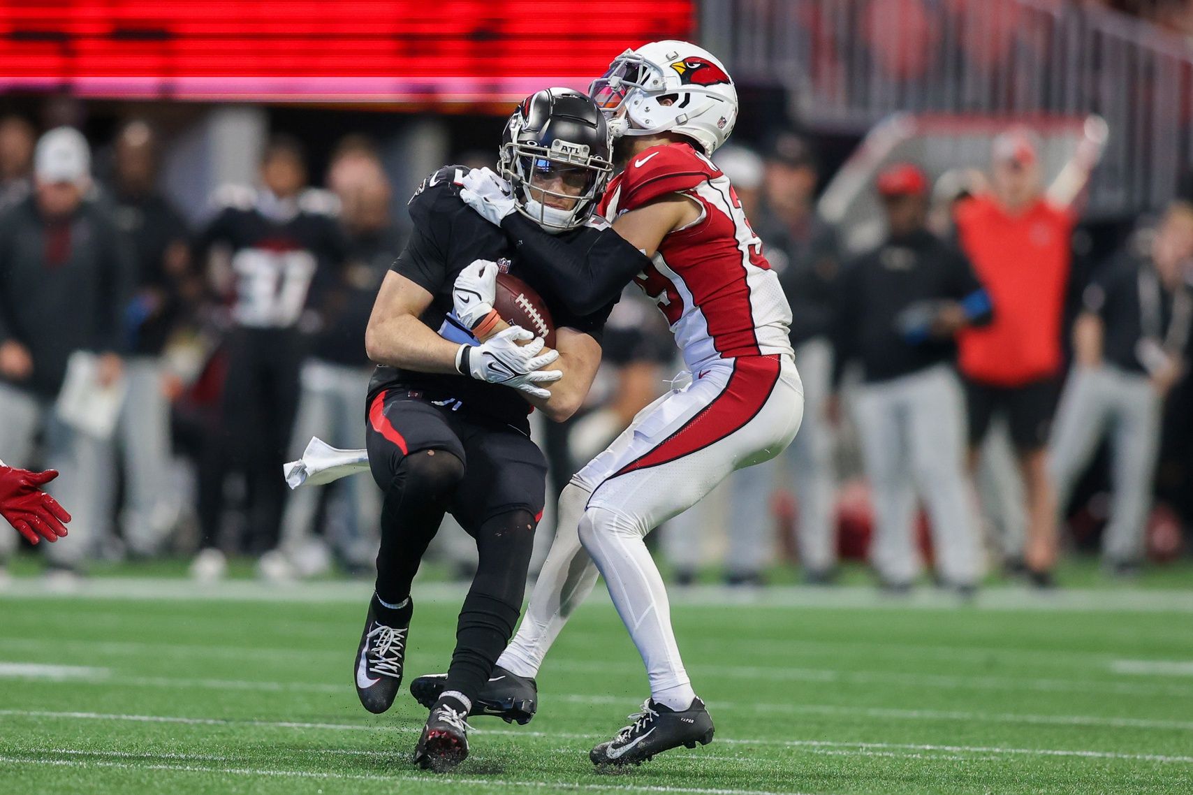 Atlanta Falcons wide receiver Drake London (5) is tackled by Arizona Cardinals cornerback Jace Whittaker (39) in the second half at Mercedes-Benz Stadium.