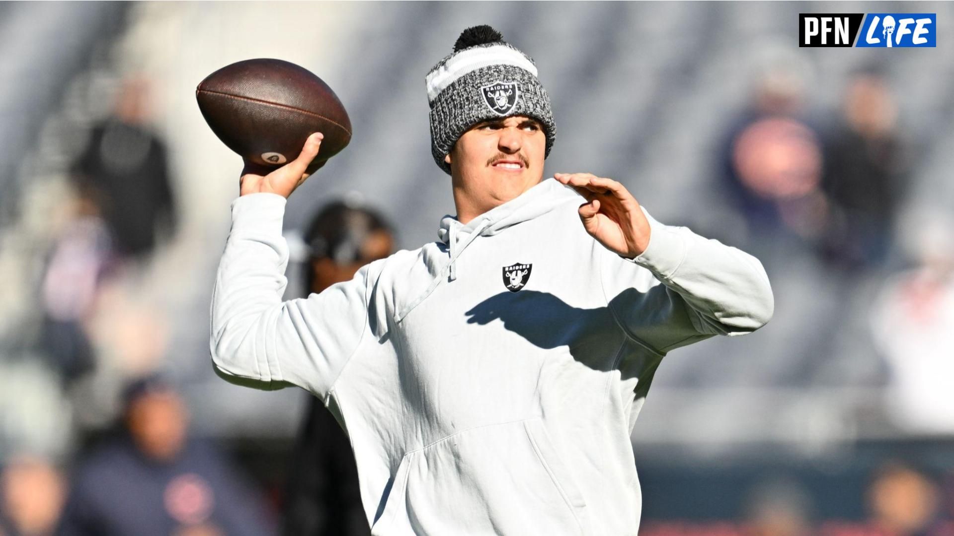 Las Vegas Raiders quarterback Aidan O'Connell (4) warms up before a game against the Chicago Bears at Soldier Field.