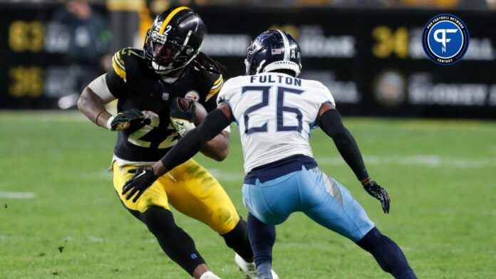 Pittsburgh Steelers running back Najee Harris (22) runs against Tennessee Titans cornerback Kristian Fulton (26) during the third quarter at Acrisure Stadium.