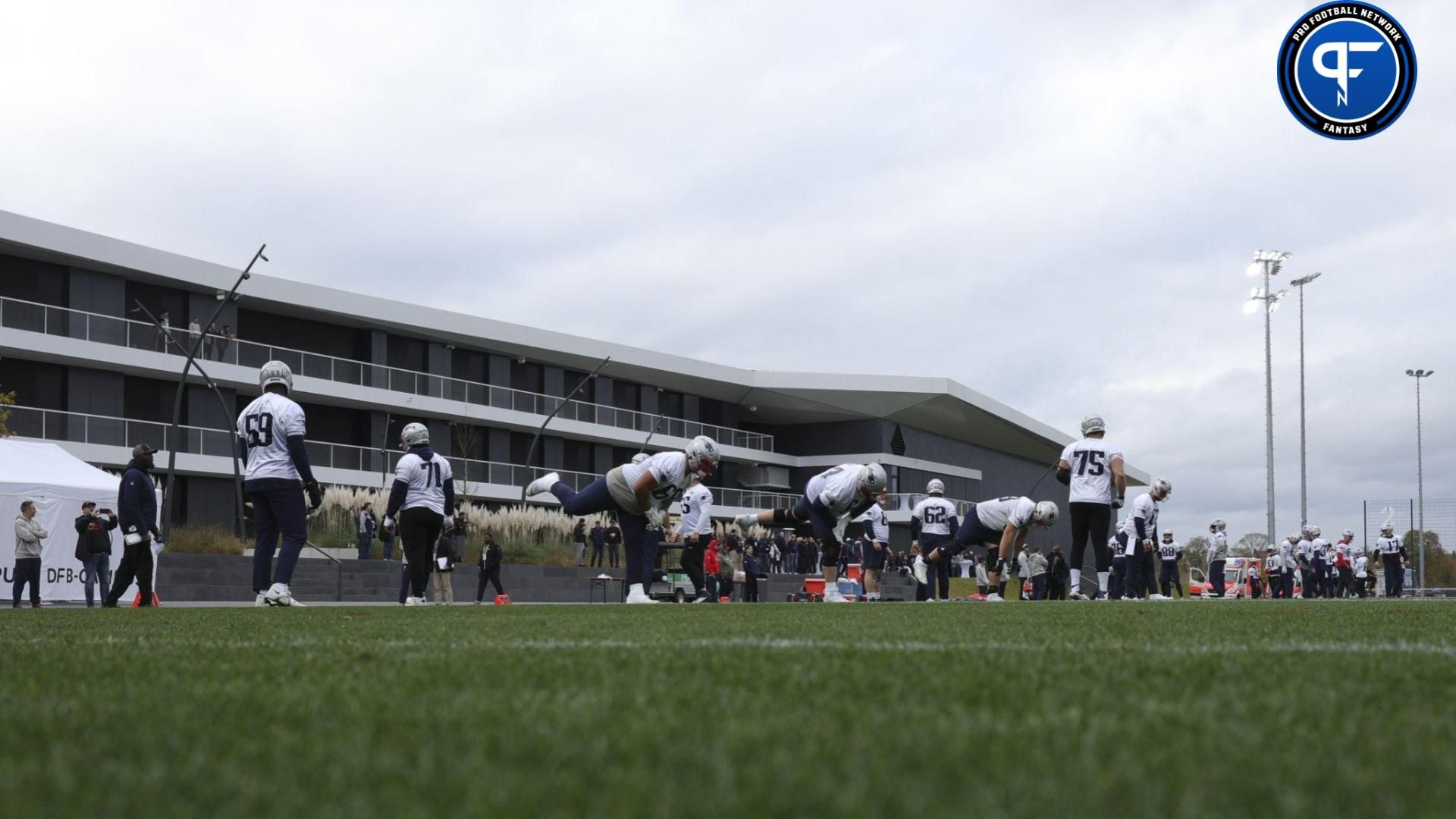 New England Patriots stretch before an NFL International Series practice at the Deutcher Fussball-Bund facility.