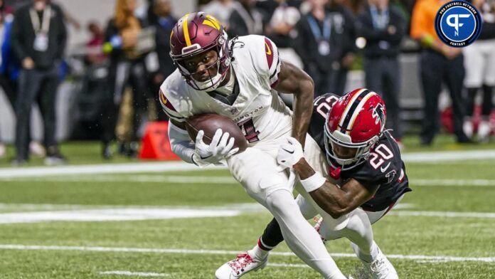 Curtis Samuel (4) runs through Atlanta Falcons cornerback Dee Alford (20) for a touchdown during the first half at Mercedes-Benz Stadium.