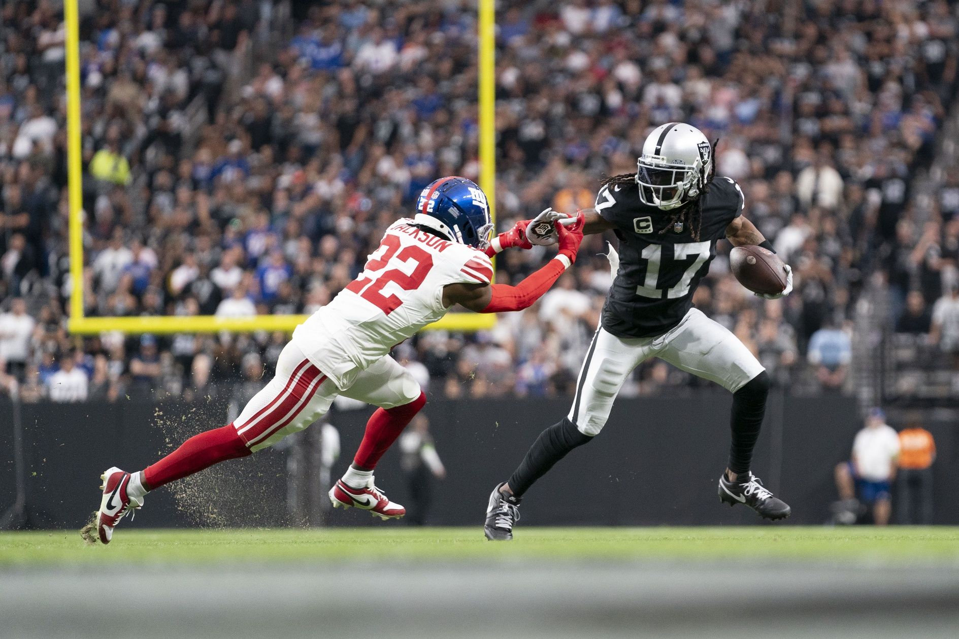 Las Vegas Raiders WR Davante Adams (17) makes a move against a New York Giants defender.