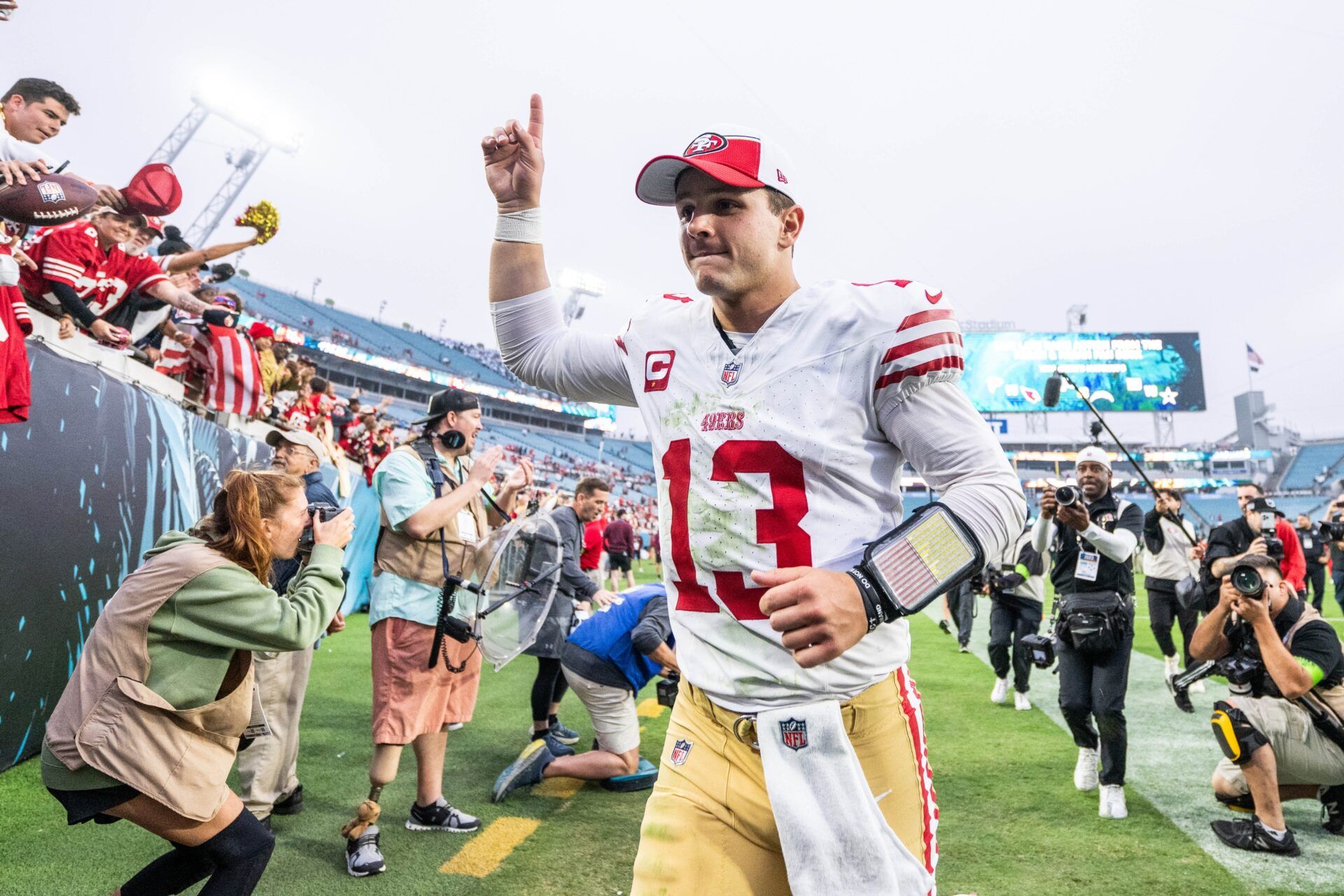 Brock Purdy (13) celebrates the win over the Jacksonville Jaguars after the game at EverBank Stadium.