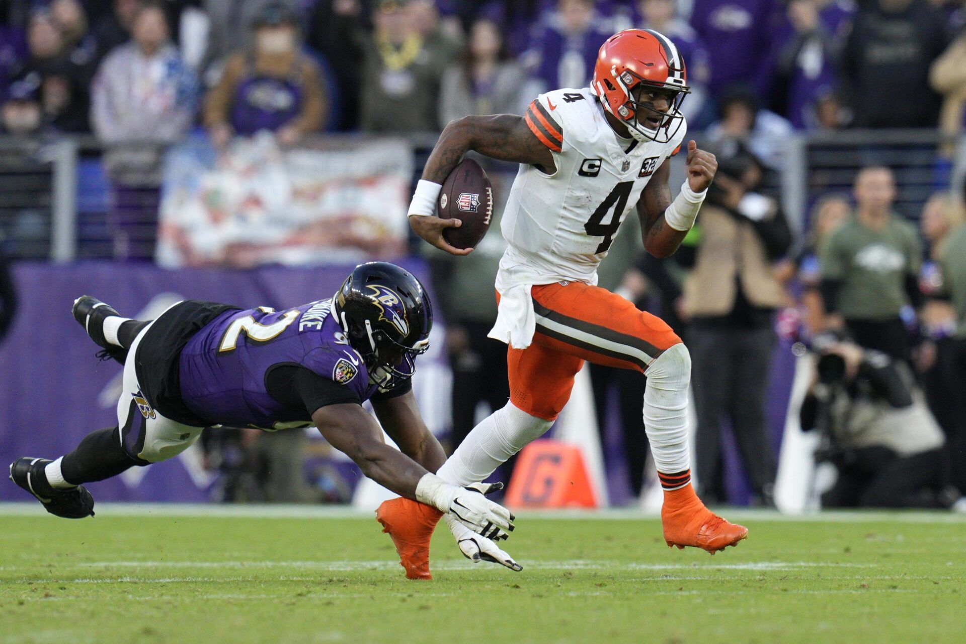 Deshaun Watson (4) runs with the ball as Baltimore Ravens defensive tackle Justin Madubuike (92) defends during the second half at M&T Bank Stadium.