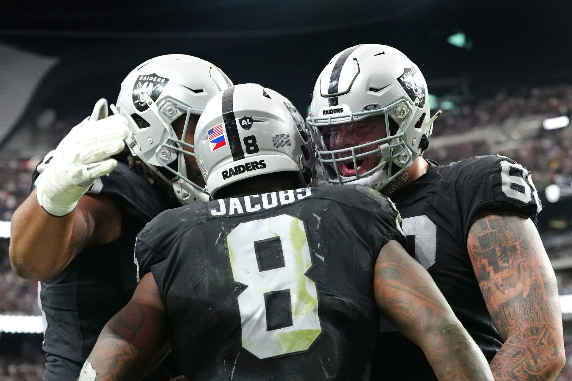 Las Vegas Raiders running back Josh Jacobs (8) celebrates with teammates after scoring a touchdown against the New York Giants during the second quarter at Allegiant Stadium.