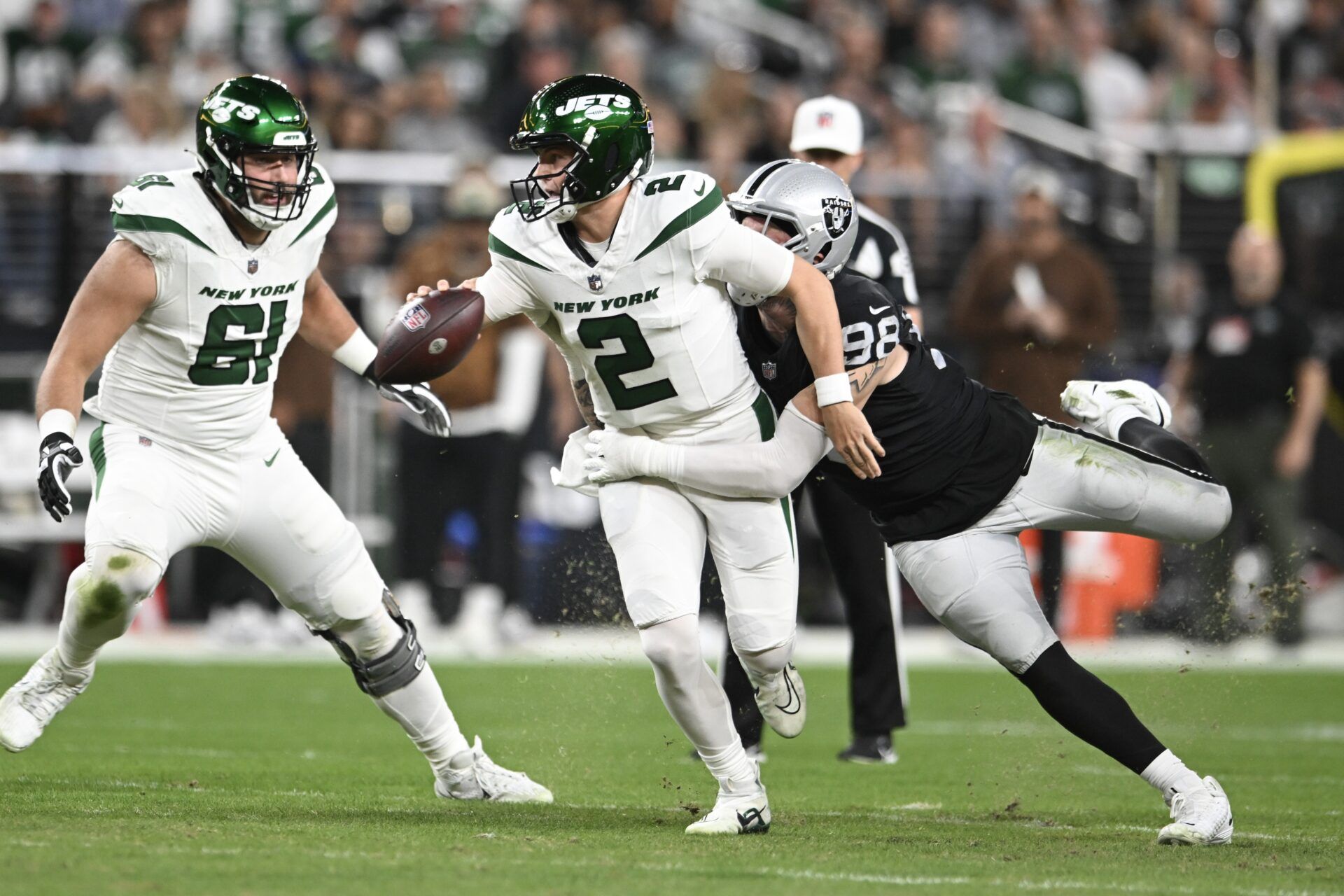 New York Jets quarterback Zach Wilson (2) is tackled by Las Vegas Raiders defensive end Maxx Crosby (98) in the first quarter at Allegiant Stadium.