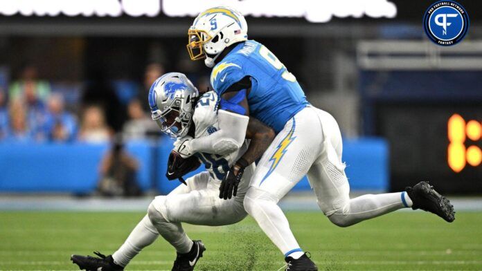 Detroit Lions running back Jahmyr Gibbs (26) is tackled by Los Angeles Chargers linebacker Kenneth Murray Jr. (9).