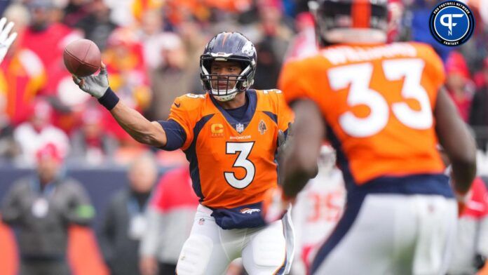 Russell Wilson (3) passes to running back Javonte Williams (33) for a touchdown against the Kansas City Chiefs in the first quarter at Empower Field at Mile High.