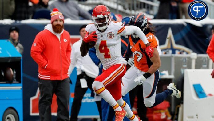 Rashee Rice (4) runs the ball ahead of linebacker Alex Singleton (49) in the second quarter at Empower Field at Mile High.